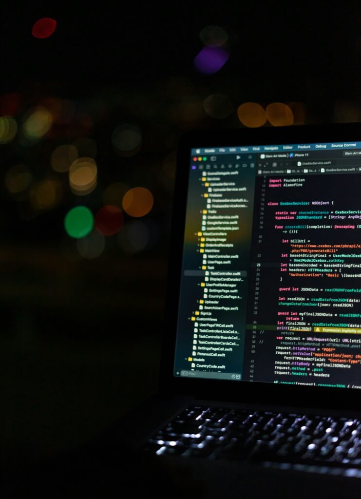 Half of a laptop screen in the dark with a pixelated background